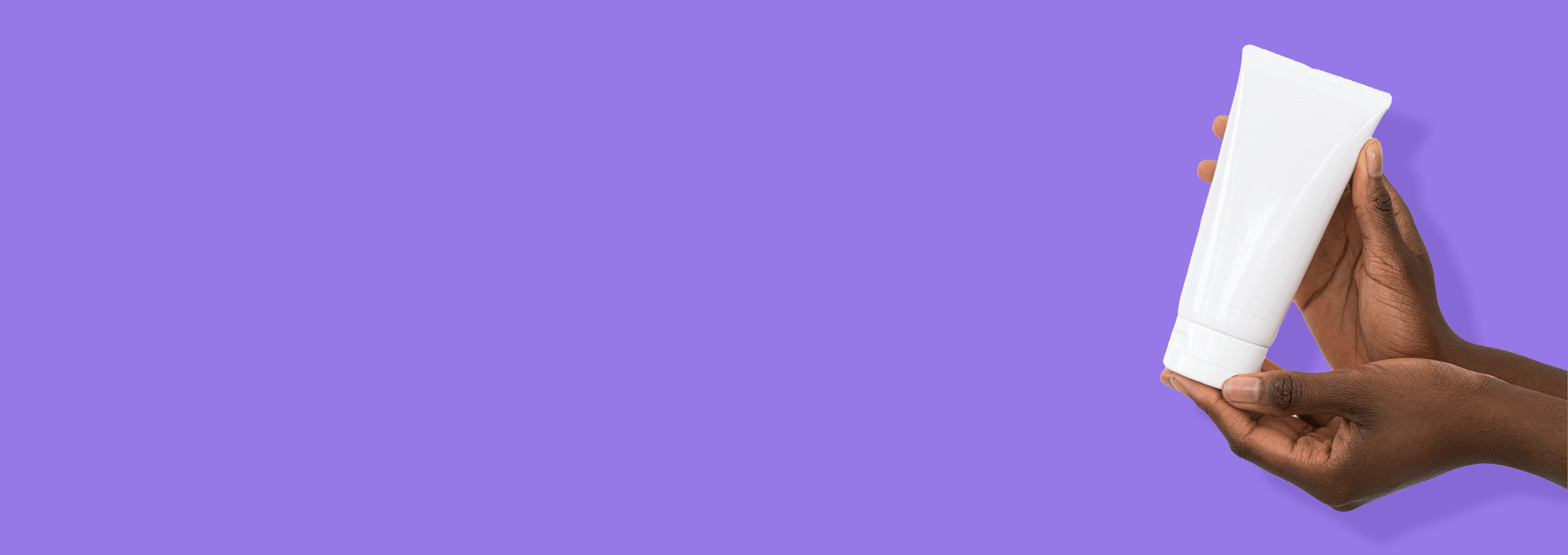 Black hand holding Cosmetic plastic tube with isolated on white background.